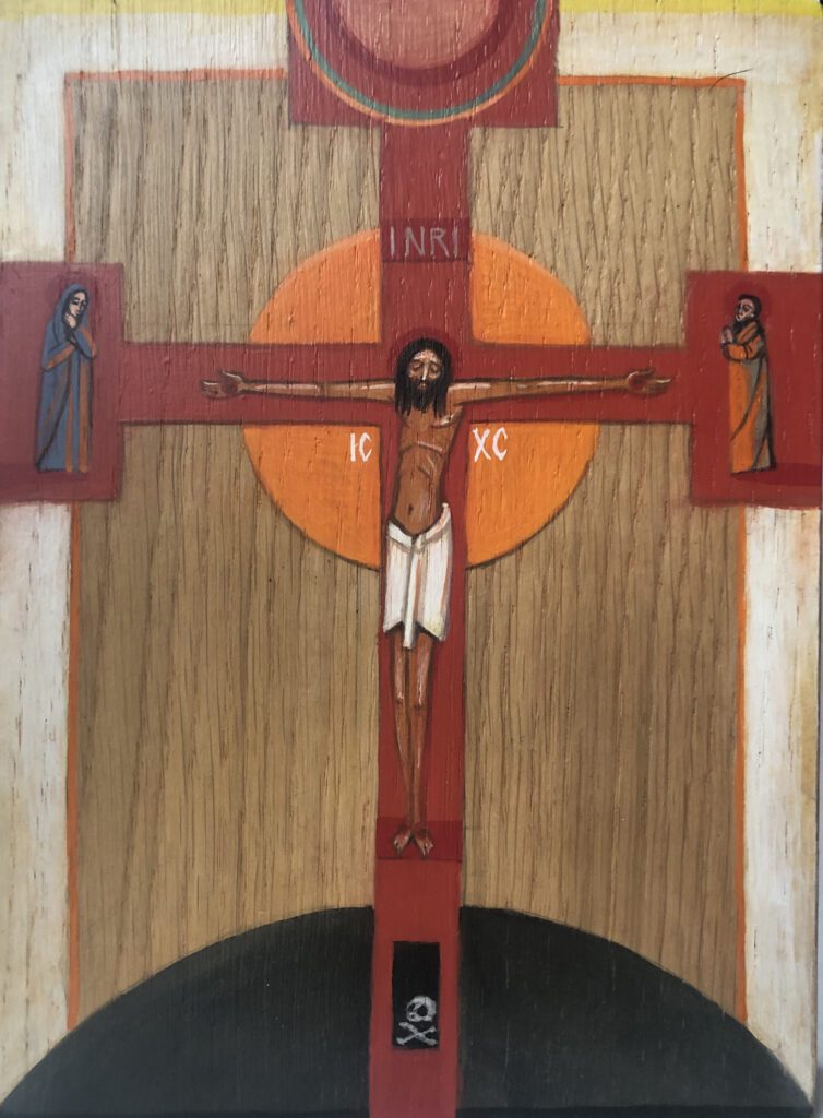Krucyfiks z Chrystusem na tle pomarańczowego okręgu